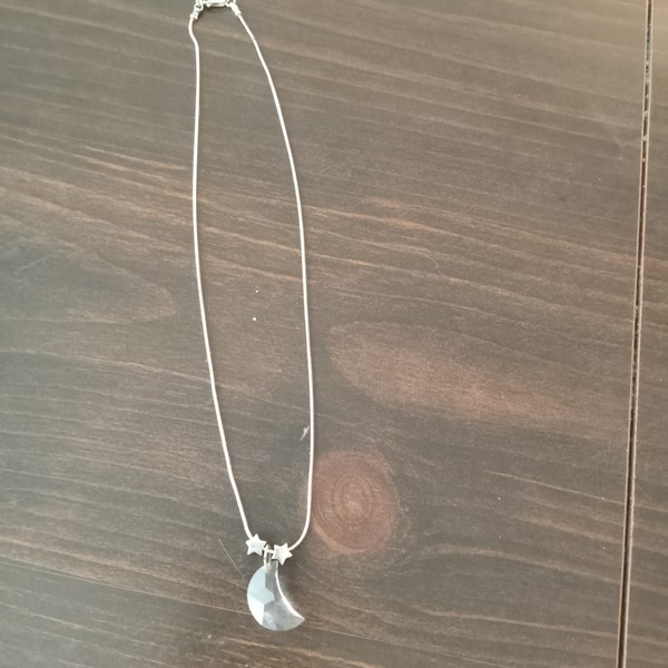 picture of faceted crystal crescent moon and two star-shaped sterling silver beads strung on silver "snake" chain