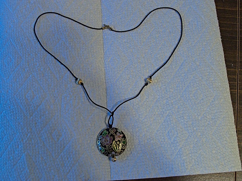 large flattened cloisonne bead strung as a pendant on silk cord with gold-filled findings.