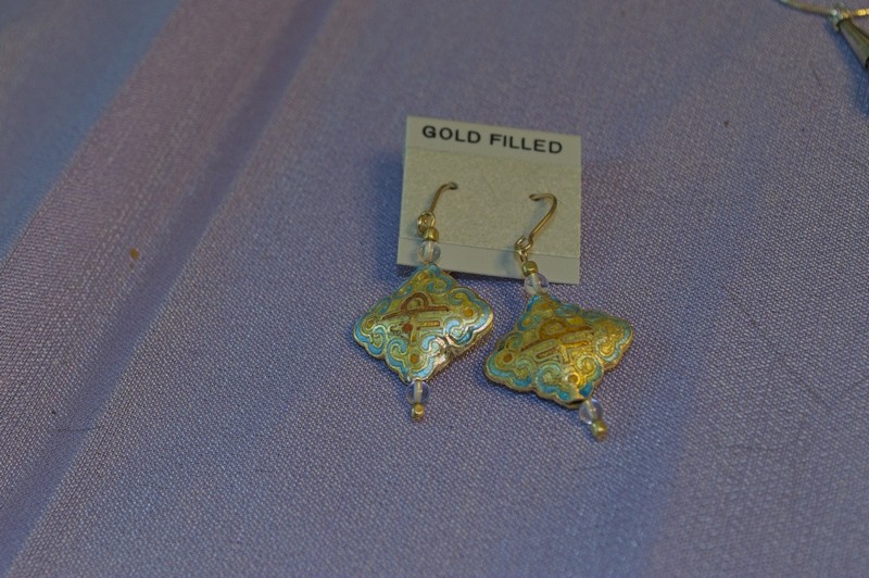 large diamond-shaped cloisonne bead with a mostly aqua background color combines with glass and gold-filled beads and findings in these drop type earrings