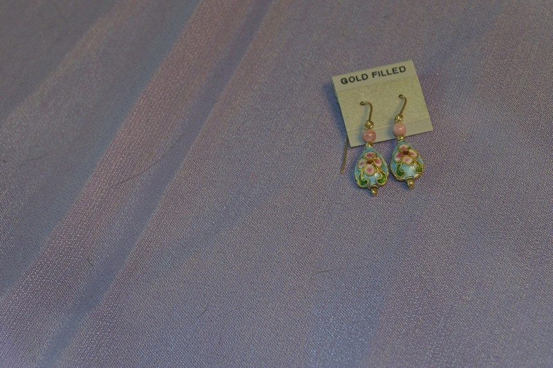 a pretty cloisonne bead with a flattened teardrop shape and aqua backgound color forms the body of these gold-filled drop earrings.