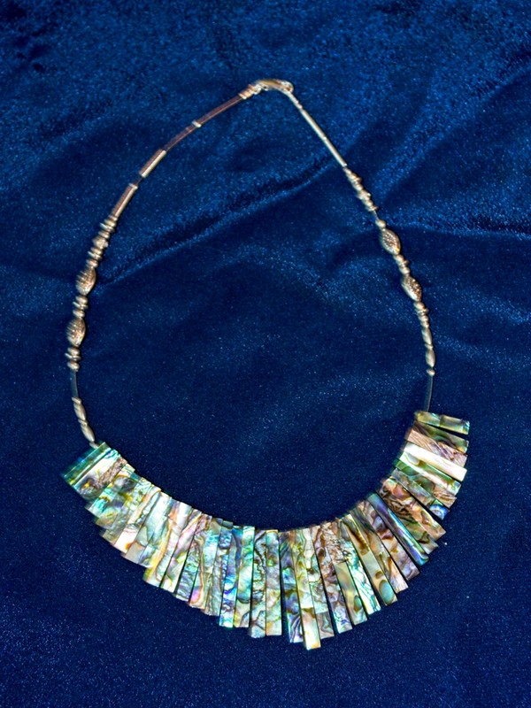 image of shimmering abalone or paua shell with fancy silver beads, strung on cable